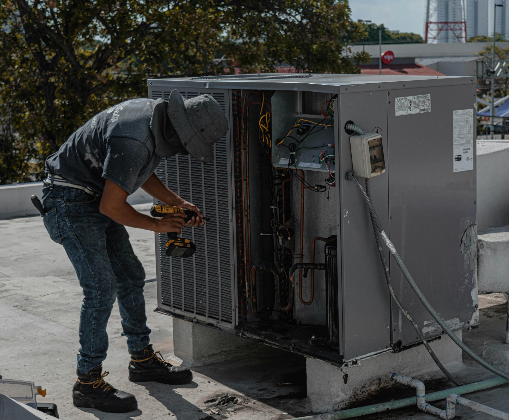 HVAC technician servicing an air conditioning unit